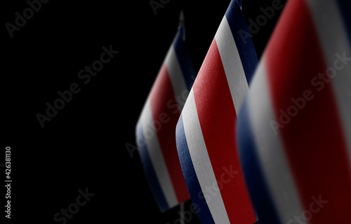 Small national flags of the Costa Rica on a black background photo