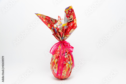 Easter Egg - Homemade chocolate egg with red ribbon. Isolated on white background