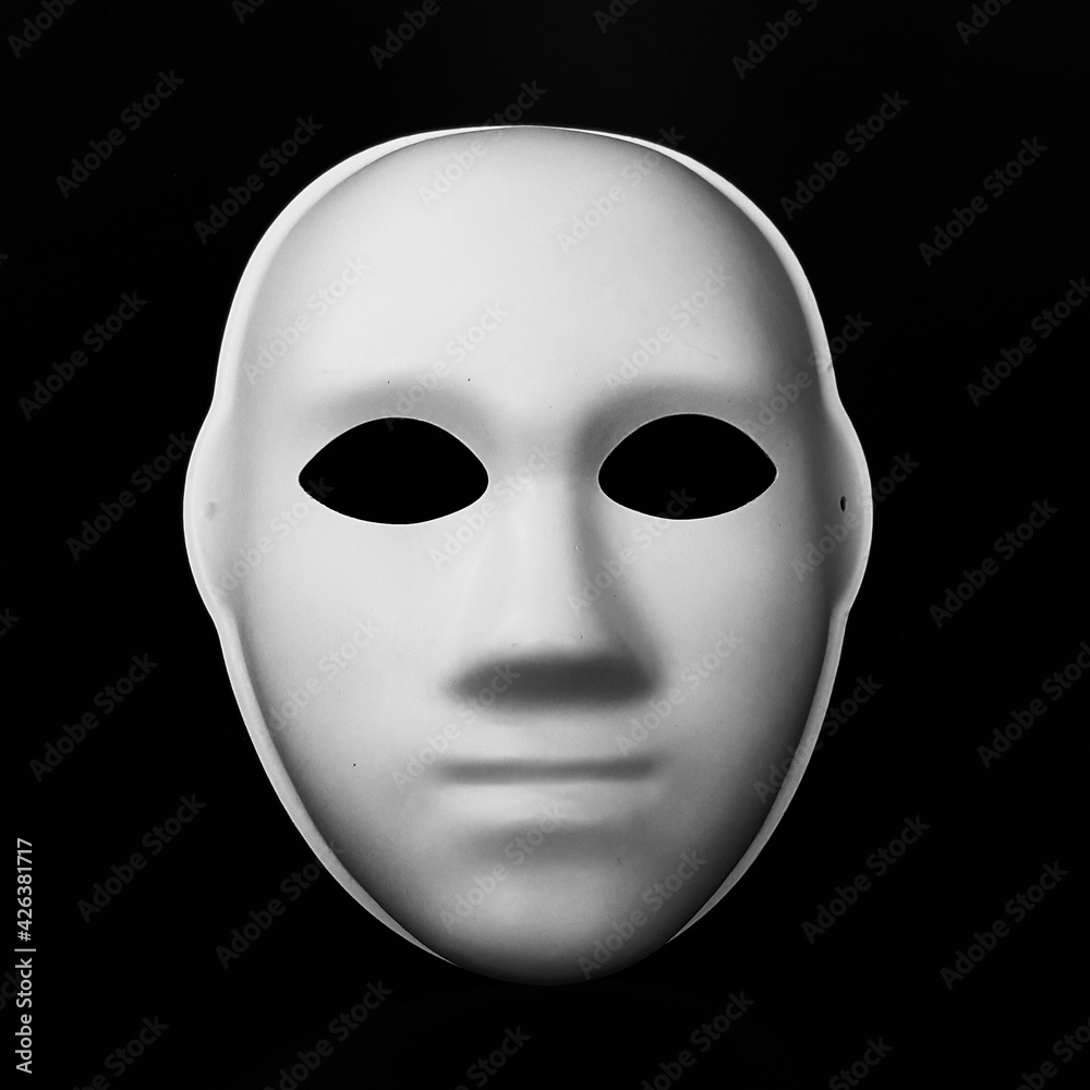 white mask in the form of a human face on a black background white mask in the form of a human face on a black background