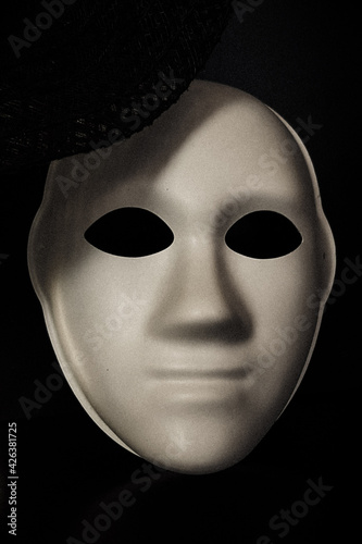 a white mask without a face on a black background. halloween background