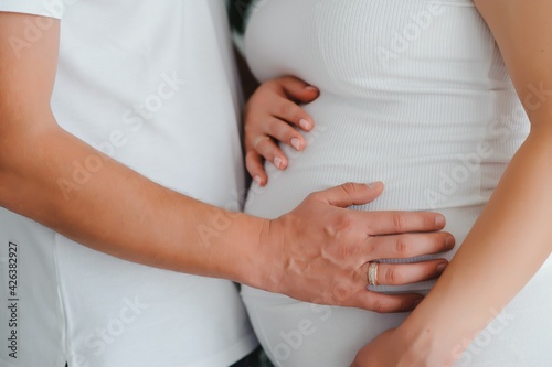 Wallpaper Mural Image of pregnant couple. Husband touching his wife belly with hands Torontodigital.ca