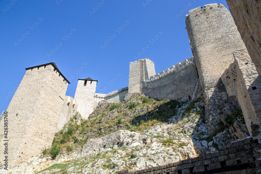 Golubac fort, a look from the ground at the towers and walls of the famous Golubac fortress on a sunny day adn clear blue sky.