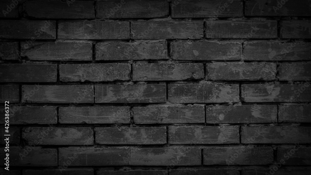 black brick wall with visible texture. background