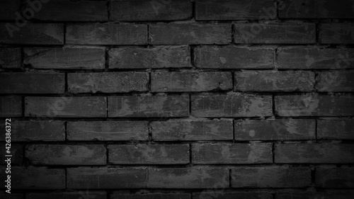 black brick wall with visible texture. background
