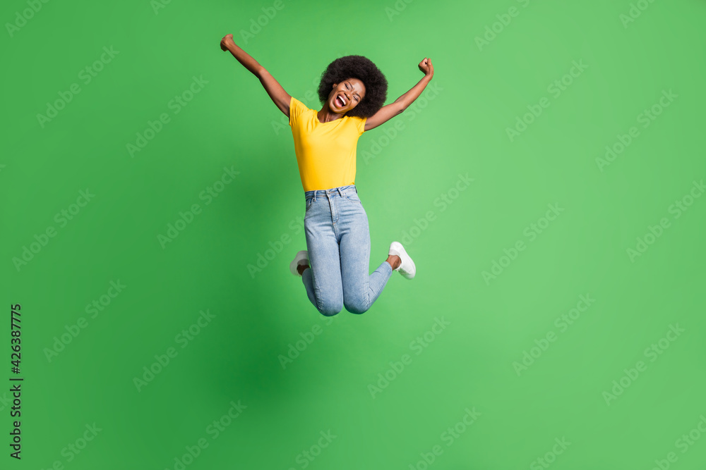 Full length body size photo of jumping girl carefree childish in casual clothes isolated on bright green color background