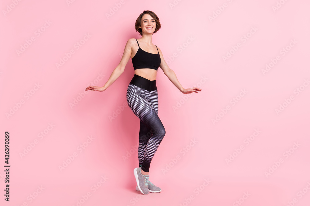 Full body photo of charming happy nice young woman smile fit slim body isolated on pastel pink color backgorund Full body photo of charming happy nice young woman smile fit slim body isolated on pastel pink color backgorund