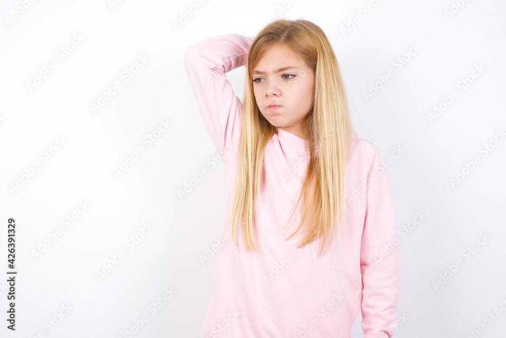 beautiful caucasian little girl wearing pink hoodie over white background saying: Oops, what did I do? Holding hand on head with frightened and regret expression. beautiful caucasian little girl wearing pink hoodie over white background saying: Oops, what did I do? Holding hand on head with frightened and regret expression.