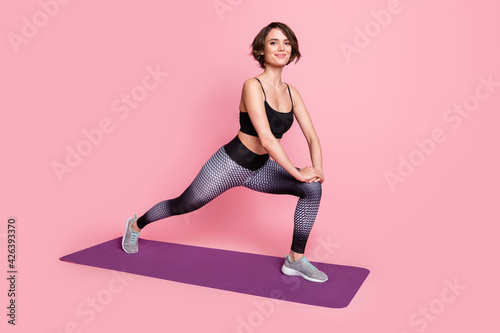 Fototapeta Naklejka Na Ścianę i Meble -  Full body profile side photo of young sportive girl happy positive smile yoga stretching isolated over pink color background