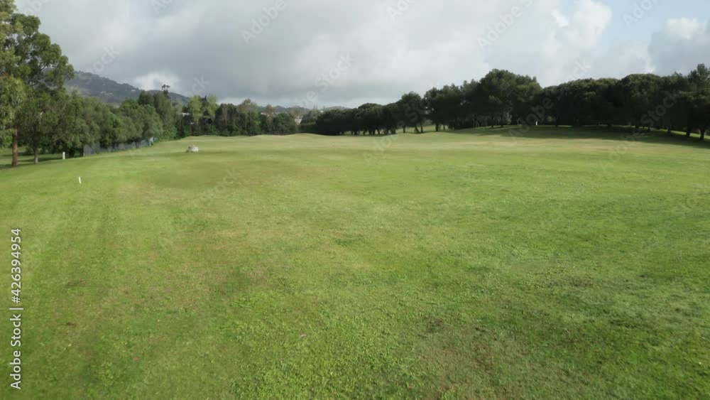Evergreen Fields Of Golf Course Fairway During Sunny Day At Clube de Golfe Beloura In Sintra, Lisbon Portugal. - Backwards Evergreen Fields Of Golf Course Fairway During Sunny Day At Clube de Golfe Beloura In Sintra, Lisbon Portugal. - Backwards