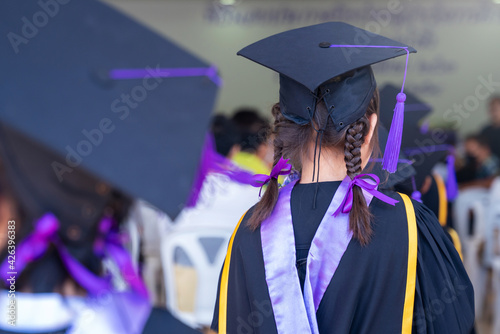 Closeup of Diploma graduating little student kid in school