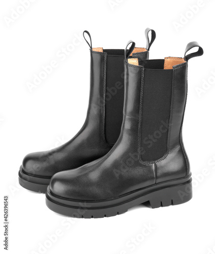 Women's shoes on a white background. Close up of a women's black leather chelsea boots on white background. Footwear for city, urban lifestyle or traveling. Concept of fashion, design and footwear.