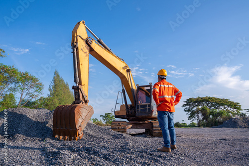 Driver excavator for road construction, Crawler excavator in construction site on blue sky background