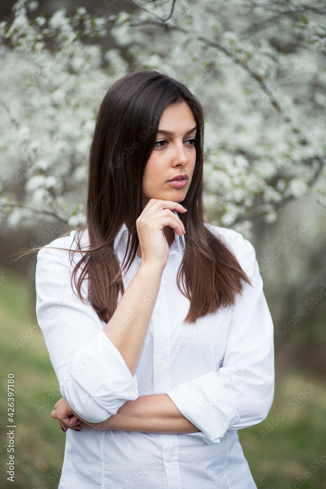 Portrait of young pretty woman among blossom trees Portrait of young pretty woman among blossom trees