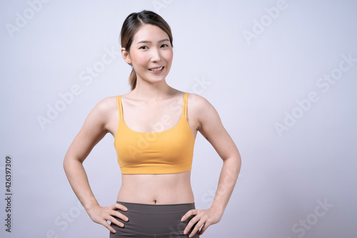 Asian women in yellow sportswear, Isolated on white background, Concept of health care and exercise.