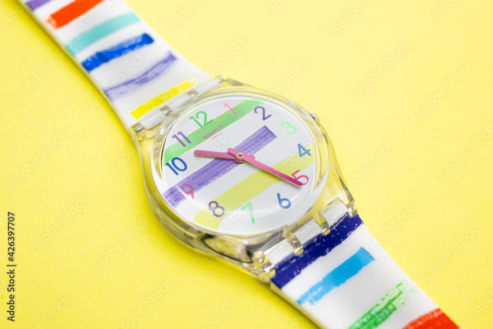 Rome, Italy 07.10.2020 - Swatch trendy fashion swiss made quartz watch  isolated on yellow background close up. transparent plastic case striped  design, youth hipster style watch for bright image. Stock Photo | Adobe  Stock