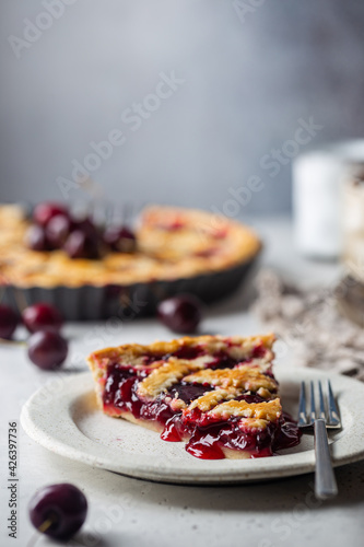 piece of Delicious homemade classic cherry pie with a flaky crust on white background