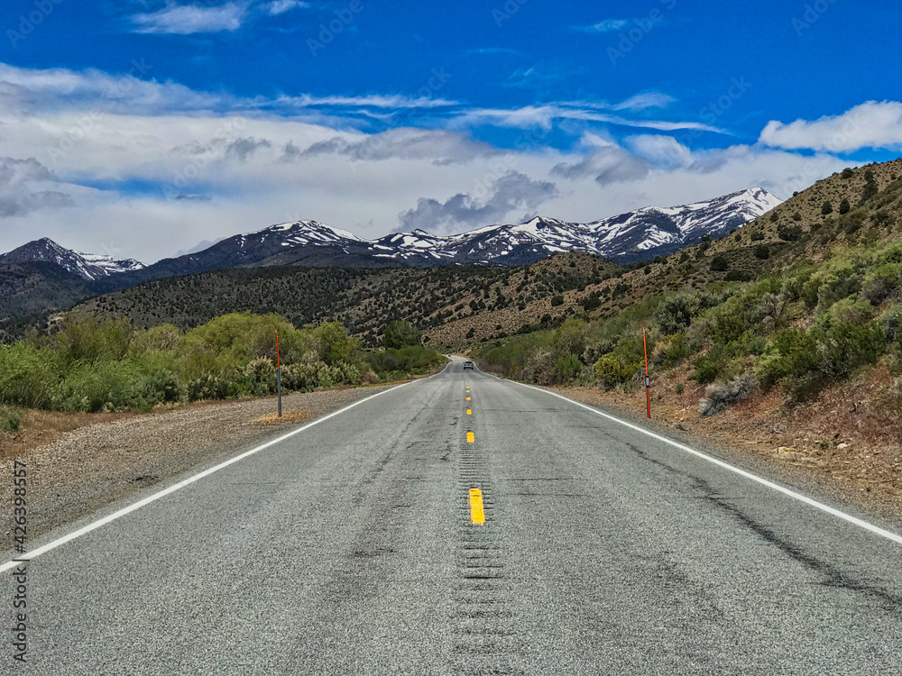Lonely asphalt road through the mountains in Nevada, USA