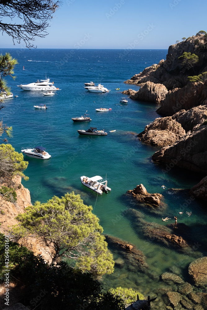 Obraz premium Rocky cove with boats in Costa Brava, Tossa de Mar, Spain