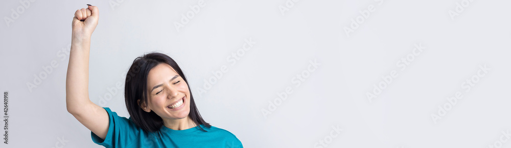 Close up portrait of attractive shouting in winning smiling with raised fists young she her girl wearing jeans shirt clothes isolated on grey background Close up portrait of attractive shouting in winning smiling with raised fists young she her girl wearing jeans shirt clothes isolated on grey background