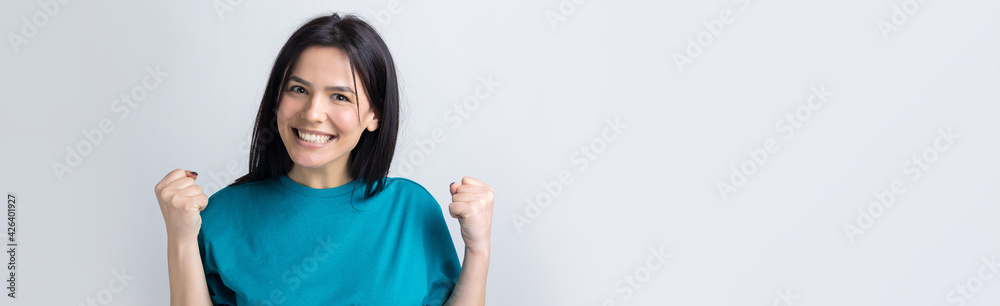 Close up portrait of attractive shouting in winning smiling with raised fists young she her girl wearing jeans shirt clothes isolated on grey background Close up portrait of attractive shouting in winning smiling with raised fists young she her girl wearing jeans shirt clothes isolated on grey background