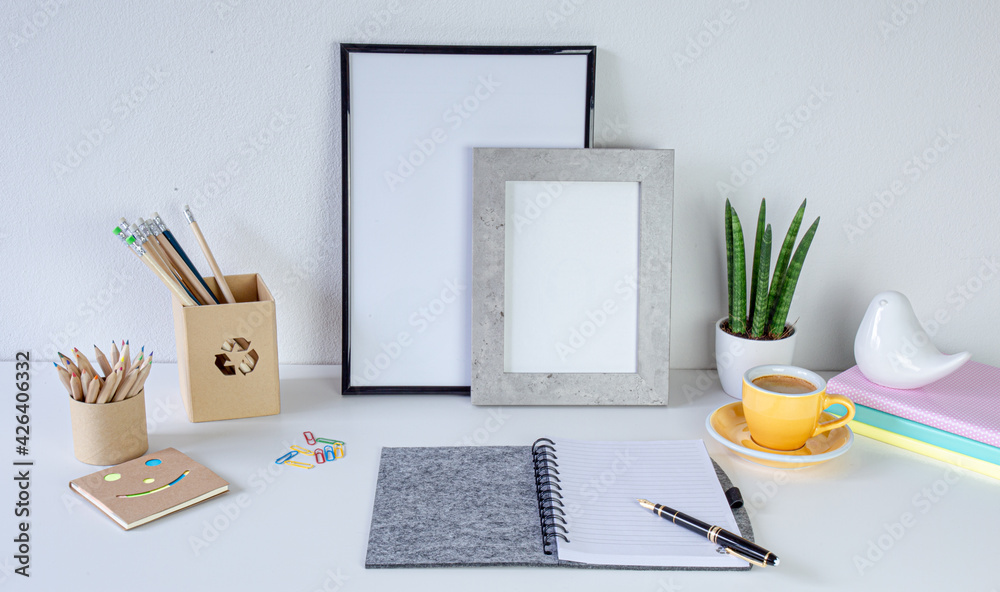 Workspace home office. Cozy home office on white table , fountain pen,  yellow cup of coffee, frame with space for tekst, notebook Background with copy space. Elegant feminine workspace.
 - obrazy, fototapety, plakaty 