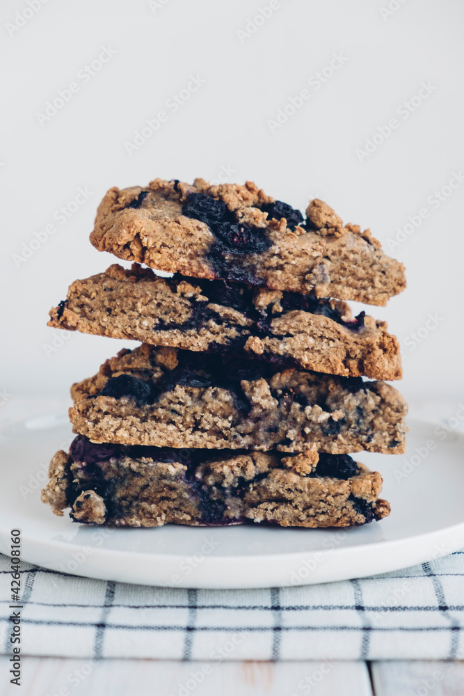 Stack of freshly baked oat blueberry scones on white plate, close up. Sweet food with natural ingredients. Vegan gluten free pastry. Stack of freshly baked oat blueberry scones on white plate, close up. Sweet food with natural ingredients. Vegan gluten free pastry.