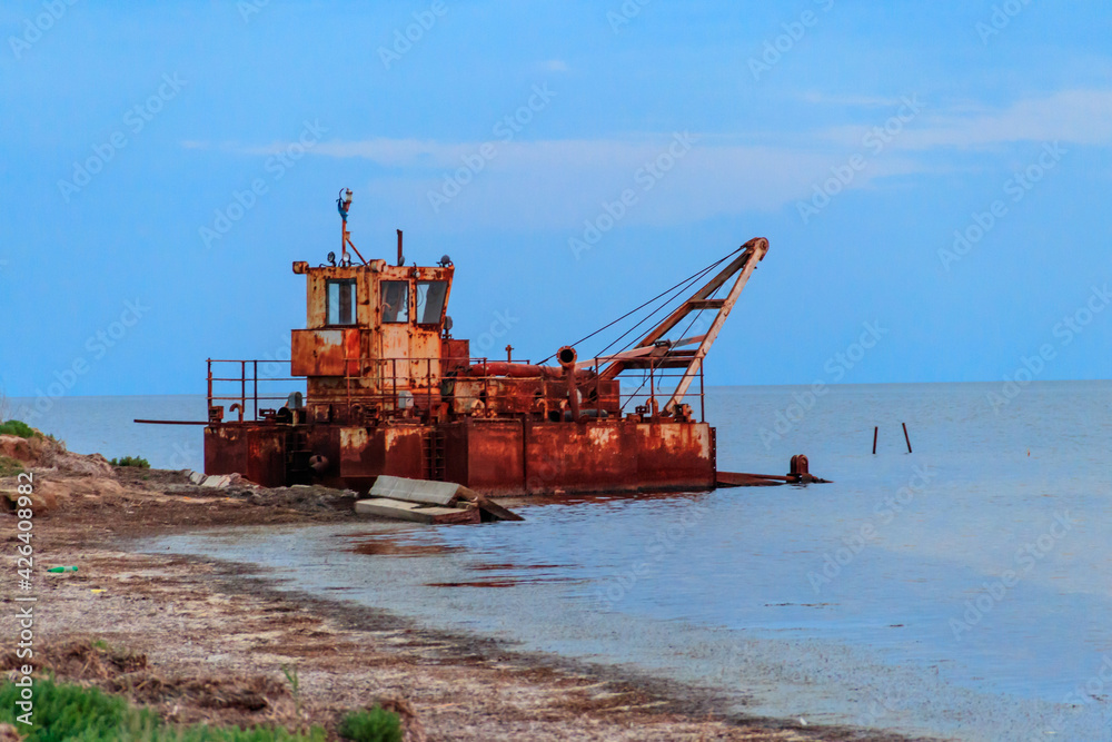 Old rusty abandoned ship on a shore of the Black sea