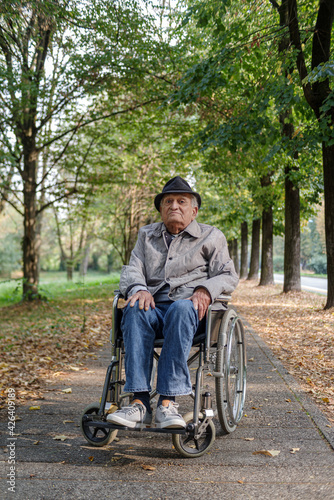 Disabled senior man in wheelchair outdoors