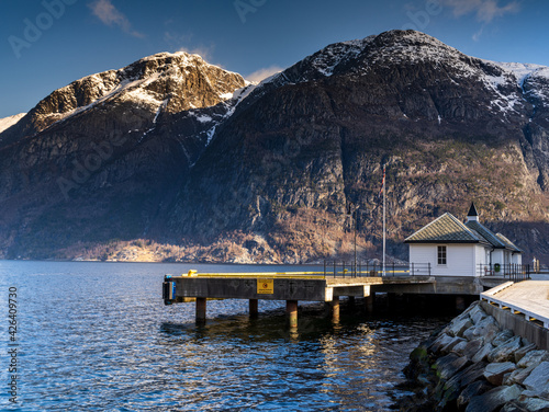 Eidfjord, a Norwegian town and municipality in the Hordaland region, view from the beach on the Eidfjorden,  the inner branch of the large Hardangerfjorden in Scandinavia photo