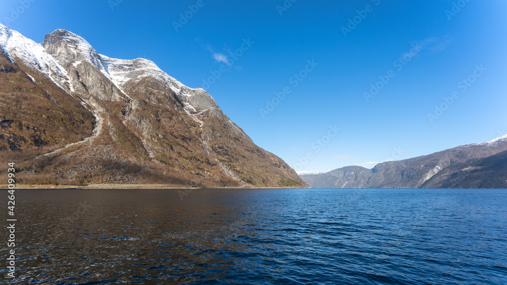 Eidfjord, a Norwegian town and municipality in the Hordaland region, view from the beach on the Eidfjorden,  the inner branch of the large Hardangerfjorden in Scandinavia