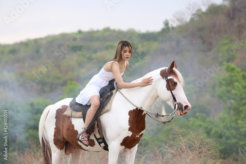 Women on skirt dress Riding Horses On field landscape Against Sky During Sunset