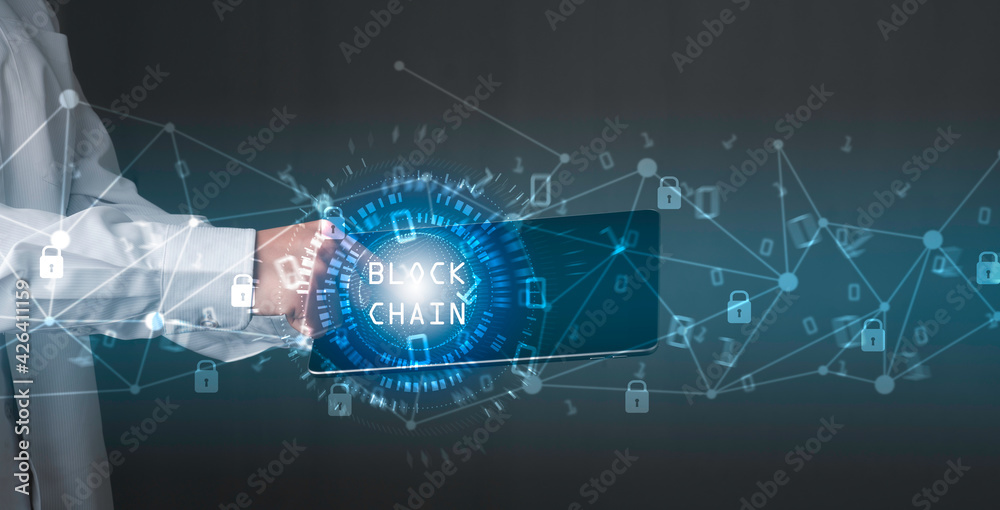 Fototapeta premium Blockchain technology concept, Businessman holding tablet and touch on screen, Binary code with connect digital technology line blue background.