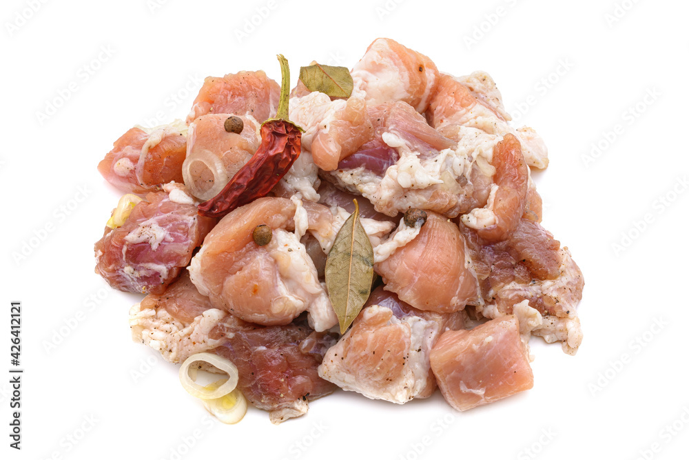 Raw pieces of pork shish kebab in marinade with pepper, onion,bay leaf, ready to cook, barbecue meat, isolated on a white background. Raw pieces of pork shish kebab in marinade with pepper, onion,bay leaf, ready to cook, barbecue meat, isolated on a white background.