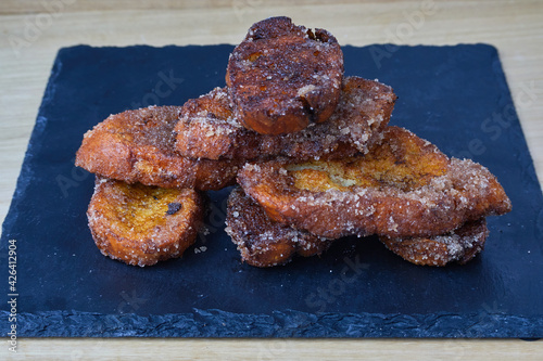 Obraz na plátne Traditional homemade and Delicious Spanish Torrijas on a black slate board