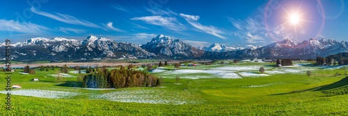 beautiful rural landscape in Bavaria with mountain range and meadow at springtime