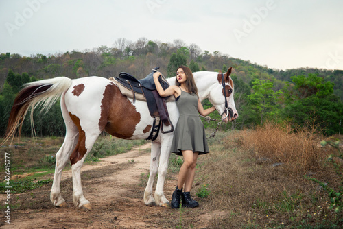 Woman with horse standing on field © FotoArtist