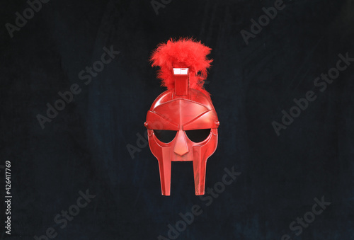 Tapety artystyczne red gladiator helmet on black background
