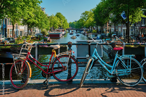 Amsterdam canal with boats and bicycles on a bridge