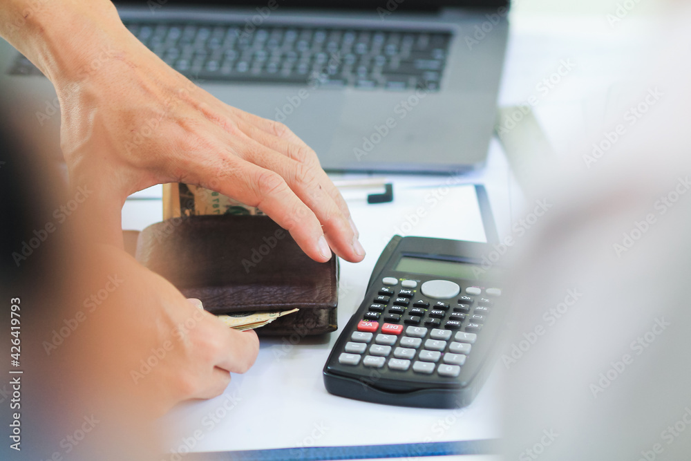 Engineers and Foreman are calculating workers' expenses and overtime to pay workers compensation and overtime each month. Foreman holds cash in hand to pay workers as compensation Engineers and Foreman are calculating workers' expenses and overtime to pay workers compensation and overtime each month. Foreman holds cash in hand to pay workers as compensation