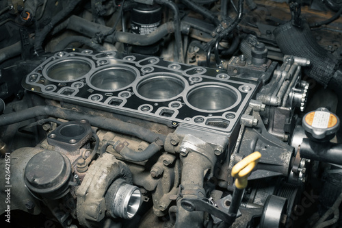 Short block with installed cylinder head gasket. Repair of a turbocharged diesel engine in a car workshop. Blur effect.