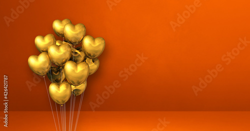 Gold heart shape balloons bunch on orange wall background. Horizontal banner.