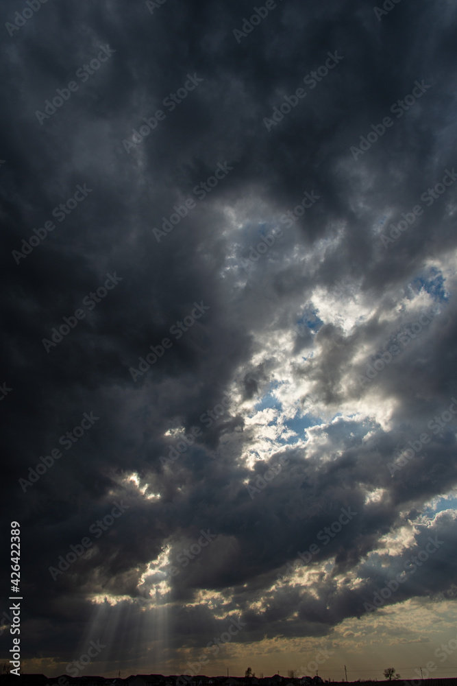 Obraz premium Rays of sunlight through dark clouds.