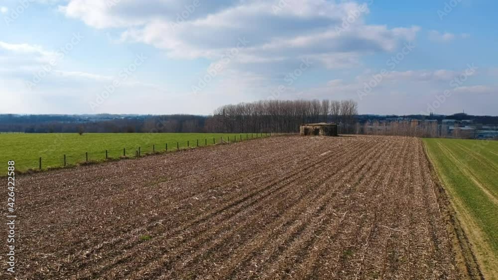 Rising aerial drone world war 2 bunker hill Belgium near city green field day Rising aerial drone world war 2 bunker hill Belgium near city green field day