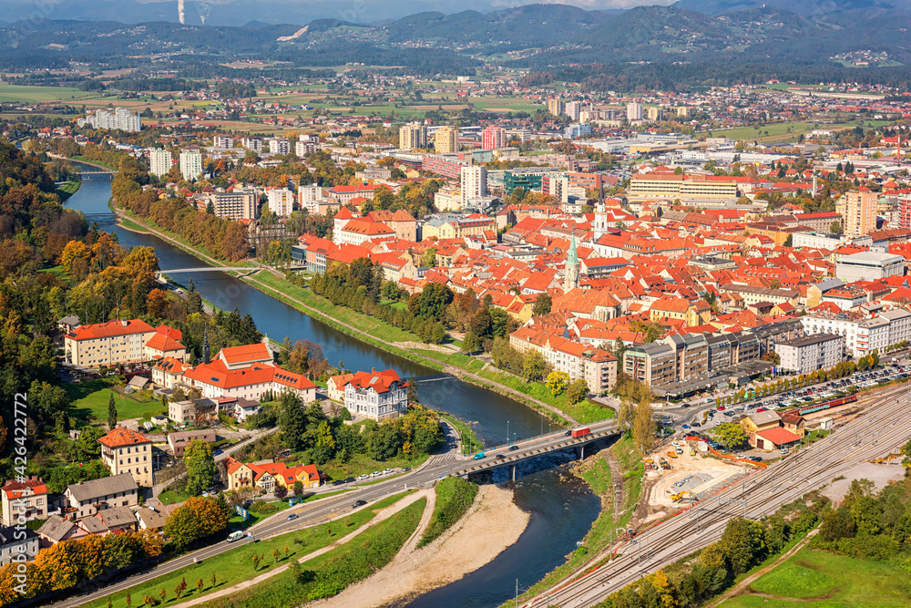 Scenic aerial view of the Celje city in Slovenia, Styria from old castle ancient walls. Amazing landscape with town in Lasko valley, river Savinja and blue sky with clouds, outdoor travel background