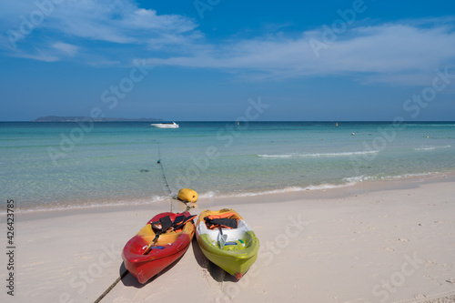 couple of colorful kayak boats on white sand beach blue sea and clear sky with clouds, relax seascape view at Thian beach, Koh Larn island, Chonburi, Thailand