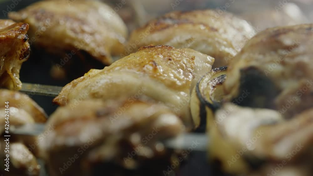 Roasted Chicken Meat and Vegetables Cooking on Bbq Hot Coal Tool Close-up. Roasting Juicy Bird Legs, Onion and Pepper on Steel Skewers Turning on Brazier. Healthy Food Cooking Outside Panning Shot Roasted Chicken Meat and Vegetables Cooking on Bbq Hot Coal Tool Close-up. Roasting Juicy Bird Legs, Onion and Pepper on Steel Skewers Turning on Brazier. Healthy Food Cooking Outside Panning Shot