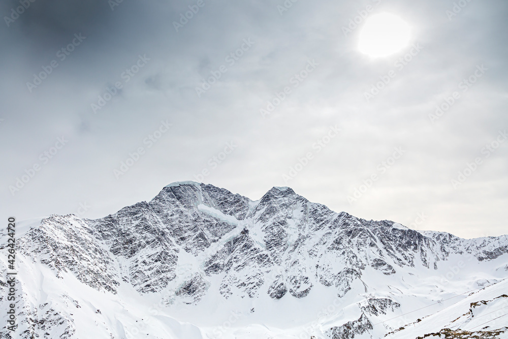 Glacier in the form of the number 7 on a mountain peak. North Caucasus, Kabardino-Balkaria, Elbrus, Russia.