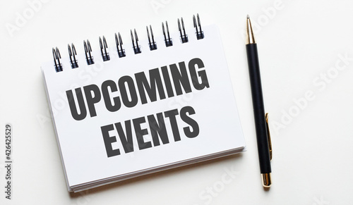 Wallpaper Mural On a light background, a white notebook with are words UPCOMING EVENTS and a pen. Torontodigital.ca