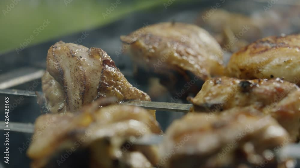 Grilled Chicken Meat and Vegetables Frying on Bbq Closeup. Roasted Bird Legs, Onion and Paprika on Metallic Skewer Rotate above Burning Coal. Delicious Food Cooking Outdoor Panning Shot Grilled Chicken Meat and Vegetables Frying on Bbq Closeup. Roasted Bird Legs, Onion and Paprika on Metallic Skewer Rotate above Burning Coal. Delicious Food Cooking Outdoor Panning Shot
