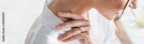 cropped view of smiling bride in wedding ring, banner.